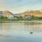 Square Whispy white clouds Oquirrh Lake at Daybreak, Utah with a view of mountain range at the back