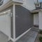 Square Whispy white clouds Side view of an exterior of a townhouses with gray and white col