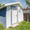 Square Whispy white clouds Small shed with blue and white color located in Utah