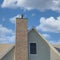 Square Whispy white clouds Two-tone bricks on a chimney post outside a house at Daybreak, U