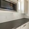 Square White kitchen interior with alcove sleek dark gray kitchen countertop