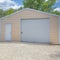 Square White puffy clouds Detached gable garage exterior with steel walls and roll-up door