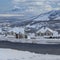 Square White puffy clouds Uphill snowy residential area at Draper in Utah with a view of W