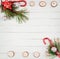 Square white wooden abstract background with fir tree, candy canes snd christmas decor at upper and lower side