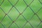 Square wire wall with blurry green background