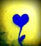 Squared painting of heart combined with plant on the wall - blue and yellow