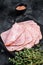 Squared slices of lean pork ham. Black background. Top view