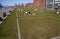 Squares painted in white on the grass in a public park for social distancing to prevent the spread of Coronavirus Covid-19.