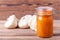 Squash caviar in a jar on the table on wooden table with white squash