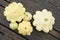 Squash, dish-shaped pumpkin, raw vegetable on a dark wooden background