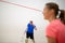 Squash players in action on a squash court