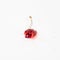 Squashed red cherry berry fruit on bright white background. Red ripe fruit concept. Healthy food idea