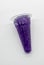 Squeezable purple jelly in plastic cone package on whit
