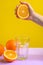 Squeeze orange juice from an orange. bright background fashion photo