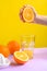 Squeeze orange juice from an orange. bright background fashion photo