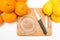 Squeezes fresh oranges with a juicer. Orange juice in a glass close to half of sliced â€‹â€‹oranges on a white background.