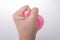 Squeezing pink balloon with hand