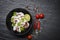 Squid salad bowl with lemon herbs and spices on dark background top view - Tentacles octopus cooked appetizer food hot and spicy