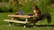 Squirrel, Sciurus vulgaris, who got her own breakfast table with flowers and food served on a garden table