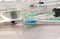 Squirting syringe needle with medicine for medical intramuscular injection on medical background