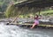 Sri Lanka, March 2018. Canoe travel on the river. Children from the coastal village  welcome tourists passing by