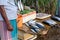 Sri Lankan fishmonger in sarong sells fish in the morning market in Weligama.