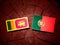 Sri Lankan flag with Portuguese flag on a tree stump isolated