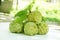 Srikaya fruit Annona squamosa with leaves, from top view, isolated white background.