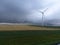 srorm front cloud rollin by wind farm