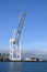 SSA Terminals crane at the Port of Seattle against blue sky