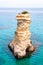 Ssea stack. Torre Sant Andrea beach with its soft calcareous rocks and cliffs, small coves and the jagged coast landscape. Crystal