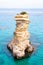 Ssea stack. Torre Sant Andrea beach with its soft calcareous rocks and cliffs, small coves and the jagged coast landscape. Crystal