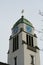 St. Agatha Roman Catholic Church in Dietikon, detail of a church tower with clock in contrasting blue and golden colors