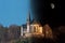 St.Anna chapel on a mountain at day and night in Germany with blue sky and moon