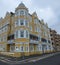 St Aubyns Mansions on Kings Esplanade, Hove, East Sussex, UK. Restored mustard coloured block of flats overlooking the sea
