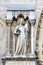 St. Denis statue on the main facade of the Cathedral of Notre Dame de Paris