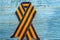 St. George ribbon on a wooden background. Symbol of courage and victory, May 9 and February 23
