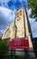 St George`s Church in Beckenham with square church tower, circular stained glass window and sign.