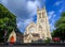 St George`s Church in Beckenham with square church tower, circular stained glass window and sign.