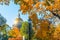 St. Isaac`s Cathedral in autumn, yellow orange leaves, street lights, Saint-Petersburg.