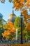 St. Isaac`s Cathedral in autumn, yellow orange leaves, street lights, Saint-Petersburg.