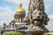 St. Isaac& x27;s Cathedral out of focus, in the foreground the sculpture of lions on a pole, Saint-Petersburg, Russia.