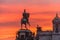 St. Isaac`s Cathedral in the square, in St. Peterburg in the evening on a bright orange sunset sky, left monument-rider on horse