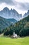 St. Johann in Ranui - a small church in front of the Dolomite mountais Geissler massif