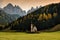 St. Johann San Giovanni in Italian Chapel in Val di Funes with the Dolomites Odle group on background.