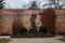 St. John of Nepomuk baroque statue, Czech patron Jan Nepomucky, Benedictine monastery Brevnov, brick walls, Garden and park, abbey