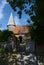 St Johns Church entrance and spire. Piddinghoe, East Sussex. UK