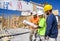 St. Louis, Missouri, United States-April 4, 2018-Three male construction workers, carpenters, wearing hardhats look at blueprints