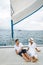 St Lucia, couple men and woman watching sunset from sailing boat in the Caribbean sea near Saint Lucia or St Lucia