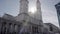 St. Ludwin church in Munich against the sunlight with a big sunlight lensflare in between the churchtowers. Slow Motion